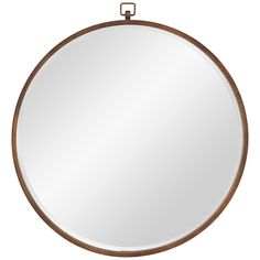 a round mirror with a metal frame and wooden trim around the edges, hanging on a white wall