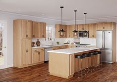 a large kitchen with wooden floors and cabinets