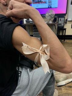 a man with his arm wrapped in a bow