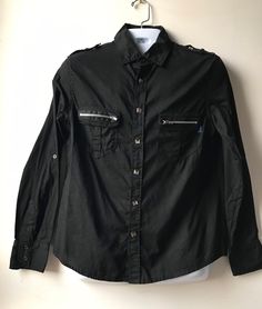 Size: L Brand: Daang Goodman for Tripp NYC Closure: Snaps This MENS black dress shirt features metal rivet snaps in the front and shoulder and zippers on the functional front pockets. Condition: Preowned vintage great. Only worn a few times. No rips, stains or imperfections. Long Sleeve Punk Shirt For Alternative Fashion, Punk Long Sleeve Shirt For Alternative Fashion, Fitted Alternative Fashion Shirt, Black Long Sleeve Rock Tops, Alternative Black Long Sleeve Shirt, Alternative Style Black Long Sleeve Shirt, Black Long Sleeve Alternative Shirt, Fitted Alternative Style Shirt For Alternative Fashion, Fitted Shirt For Alternative Fashion