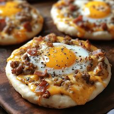 small pizzas with bacon and an egg on top