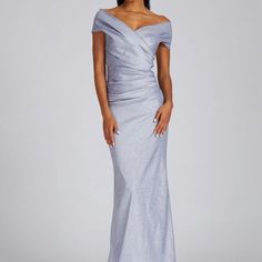 a woman wearing a silver gown with one shoulder and an asymmetrical top