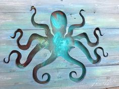 an octopus is painted on the side of a wooden planked wall with metal accents