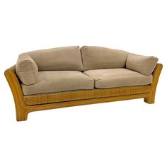 an image of a couch that is made out of wood and beige velvet fabric on the back