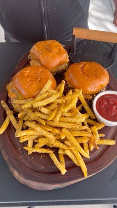 burgers and french fries on a plate with ketchup