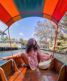 a woman sitting in the bow of a boat