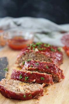 sliced meatloaf sitting on top of a cutting board