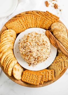 a cheese ball surrounded by crackers on a plate