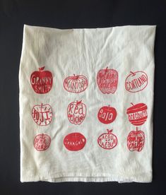 a white cloth with red apples and words on it that read granny smith, country style