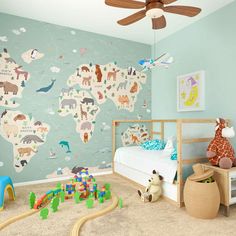 a child's bedroom decorated in blue and green with animals on the map wallpaper