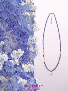 Inspired by the ethereal beauty of a lavender garden, the Violet Elegance Tanzanite Necklace captures the essence of mystery and sophistication. This exquisite necklace features violet tanzanite beads, known for their sparkling facets and deep hues, accented with natural turquoise, freshwater pearls, and South Red Agate. The design is finished with 925 silver plated with gold, creating a harmonious and elegant piece. This necklace embodies the calming and transformative properties of tanzanite. Elegant Lavender Beaded Necklace With Gemstones, Lavender Necklace With Faceted Beads Gift, Lavender Faceted Beads Necklace For Gifts, Blue Amethyst Necklace With Natural Stones, Blue Beaded Amethyst Necklace, Elegant Lavender Beaded Necklace With Natural Stones, Blue Tanzanite Gemstone Beads Necklace, Blue Amethyst Necklace For Healing, Blue Amethyst Gemstone Necklaces