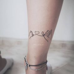 a woman's leg with tattoos on it and two birds in the sky above her