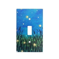 a light switch cover with grass and stars in the night sky on blue, green and white