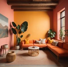 a living room with orange and yellow walls, large potted plants on the far wall