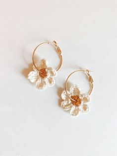 the small flower hoop earrings are made from gold plated brass and white crochet