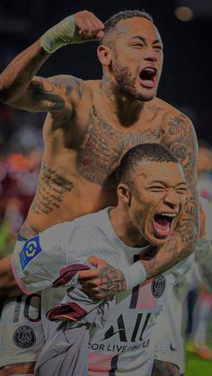 two soccer players with tattoos on their arms