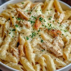 pasta with chicken and parsley in a white bowl