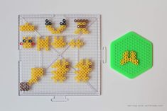 a lego board with some animals on it and a green hexagonal object next to it