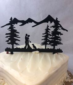 a cake with frosting and silhouettes of two people holding hands on top of it