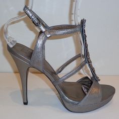 Pelle Moda Fiby Pewter Leather Platform Sandals Heels New Womens Shoes -Style: Fiby -Color: Pewter Metallic Kid Suede -Kid Suede Upper -Man Made Lining -Leather Outsole -Padded Insole -Heel Height Approximately 5.5(10)5.75(11) Inches -Platform Height Approximately 1 Inch Sku 3093d(10)3096d(11) Silver Sandals With Padded Heel For Night Out, Formal Silver Heels With Buckle Closure, Silver Open Toe Sandals For Cocktail, Silver Open Toe Heels For Formal Occasions, Silver Formal Sandals, Elegant Metallic Open Heel Shoes, Silver Closed Toe Sandals For Formal Occasions, Silver Sandals With Padded Heel For Formal Occasions, Formal Silver Sandals With Padded Heel