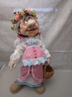 an old fashioned troll doll holding a basket