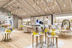 the inside of a store with tables, stools and other items on display in it