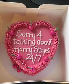 a heart shaped cake in a box with the words sorry 4 talking about harry styles