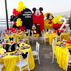 a mickey mouse themed birthday party with yellow tablecloths