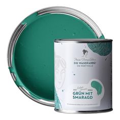 a can of green paint next to a white background