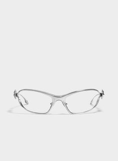 a pair of glasses sitting on top of a white surface