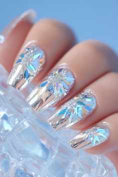 Add a touch of winter magic with Artistic Wonderland Nails, featuring a shiny silver base and shimmering snowflake decals for a mesmerizing, 3D effect. The sharp, elongated shape enhances the intricate details, making this winter nails design the perfect balance of elegance and modern charm for the season.  #ArtisticWonderlandNails #WinterNails #SnowflakeNailArt #SilverNails #3DNailDesign #HolidayNailInspo #WinterElegance #GlamNails Winter Nails Design, Wonderland Nails, Nails Sparkling, 3d Nail Designs, Snowflake Nail Art, Glitter Flake, Snowflake Nails, Winter Nail Designs