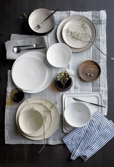 the table is set with dishes and utensils