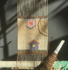 a close up of a weaving machine with yarn on it and a needle in the middle