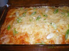 a casserole dish with green onions and cheese