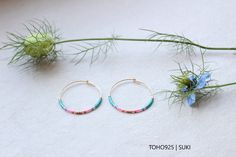 **SUKI** These delicate, filigree "SUKI" hoop earrings are made of 14 carat gold filled and Miyuki Delica beads 11/0 (diameter: 1.6 mm). The hoop earrings measure 30 x 0.7 mm. MINIMALISTIC - TIMELESS - ELEGANT Also available in 925 sterling silver. (please write to me) Photos: Zoom shots! Please note dimensions. The "SUKI" model consists of the colors water blue, pink & matt gold. Nickel FREE The hoop earrings come to your home wrapped in tissue paper with an organza bag. Gold filled is a proces Miyuki Delica Beads, Water Blue, Delica Beads, Jewelry Earrings Hoops, Organza Bags, Blue Water, Base Metal, Pink Gold, Tissue Paper