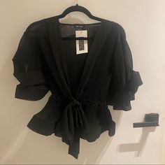 The Perfect Top For A Fancy Night Out! Never Worn (Still Has Tag From The Boutique). It Really Is A Statement Piece! Elegant Black Top For Night Out, Elegant Black Top For Going Out, Glamorous Black Tops For Spring, Flirty V-neck Evening Top, Flirty Black Party Top, Flirty Black Top For Going Out, Glamorous Black Blouse For Date Night, Black Flirty Blouse For Spring, Black V-neck Blouse For Night Out