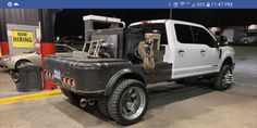 a white truck parked inside of a garage