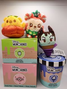 two stuffed animals sitting next to each other on top of an ice cream container and box