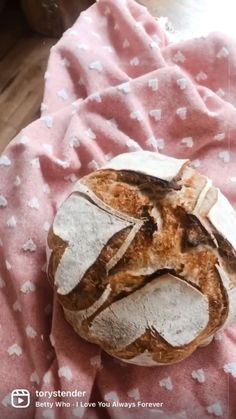 a loaf of bread sitting on top of a pink blanket