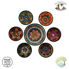 six colorful plates with designs on them are arranged in a circle and one is empty