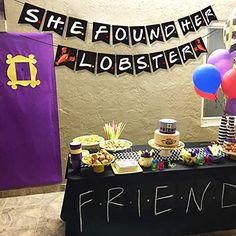 a table topped with lots of food and balloons