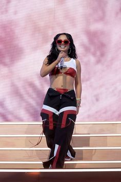 a woman in black and red outfit on stage