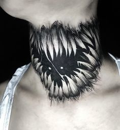 a neck tattoo with black and white flowers on it