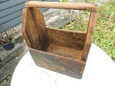 an old wooden box sitting on top of a table next to a potted plant