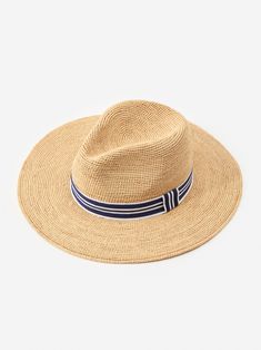 Our Freida Raffia hat is your perfect companion for the beach, horseback riding, or walks around town, or just when you just want an excuse to wear a really chic hat. | J.McLaughlin Women's Freida Raffia Hat Natural/Navy Chic Travel Fedora With Curved Brim, Chic Woven Travel Hat, Chic Fedora Hat For Travel, Chic Travel Fedora Hat, Chic Travel Hats For Kentucky Derby, Chic Travel Hats With Upf 50+, Chic Kentucky Derby Straw Hat For Travel, Chic Kentucky Derby Travel Hat, Wide Brim Woven Fedora For Travel