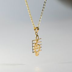 A music note jewelry, crafted in gold, a music lover's dream to hold.  This 14K gold Music Note Pendant features a treble clef on staff and is crafted into a delicate and intricate design, with every curve and swirl of the clef carefully detailed to create a sense of movement and fluidity. A music note pendant gold such as this treble clef pendant is symbolically designed to represent musical notes and rhythm, enhancing the wearer's personal style and fashion sense. Experience luxury and sophist Music-themed Yellow Gold Jewelry Gift, Personalized Gold Music-themed Jewelry, Music Note Jewelry, Music Note Necklace, Musical Jewelry, Beaded Jewels, Music Themed, Gift For Music Lover, Pendant Design