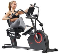 a woman is sitting on an exercise bike