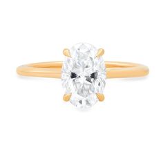 an oval cut diamond ring in yellow gold