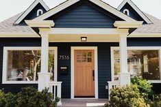 a blue house with white trim and windows