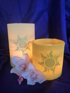 two yellow and white vases with flowers on them